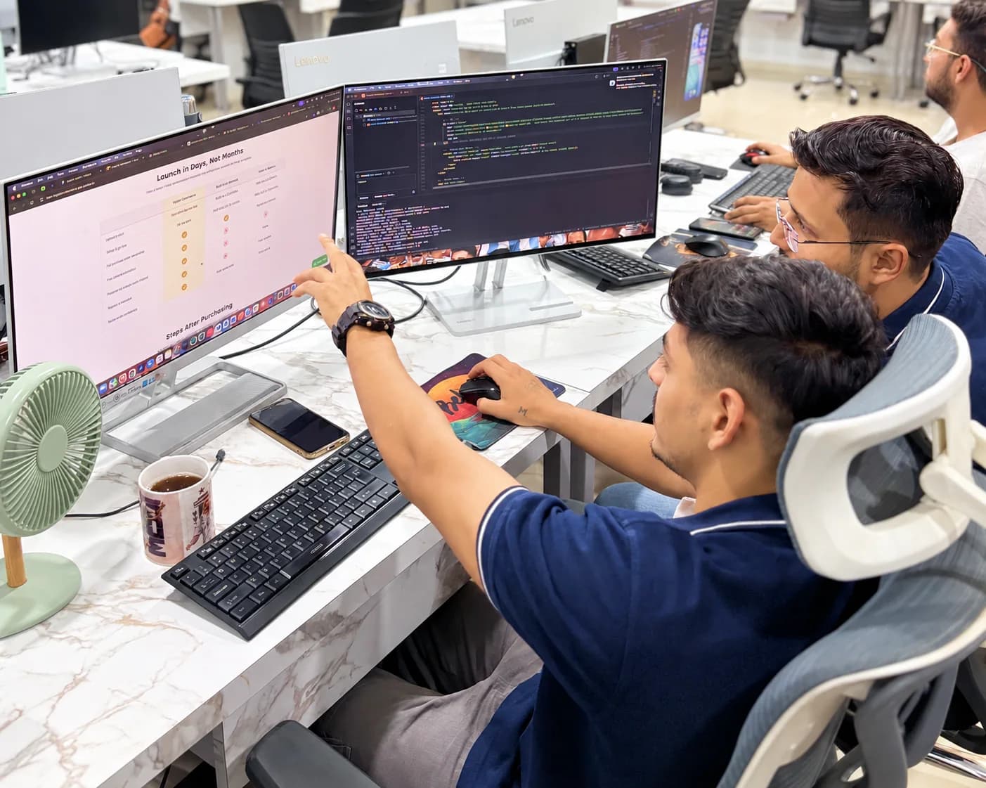 Infinitietech developers collaborating across office workstations